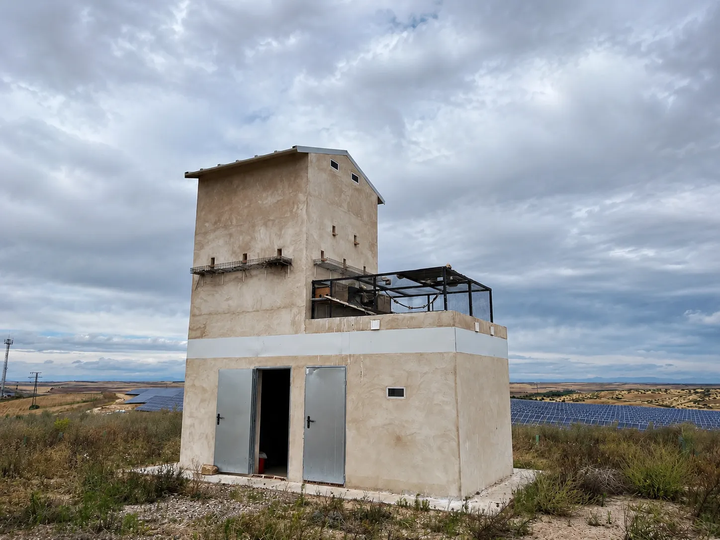 Bird shelter next to a solar photovoltaic plant in a rural landscape.