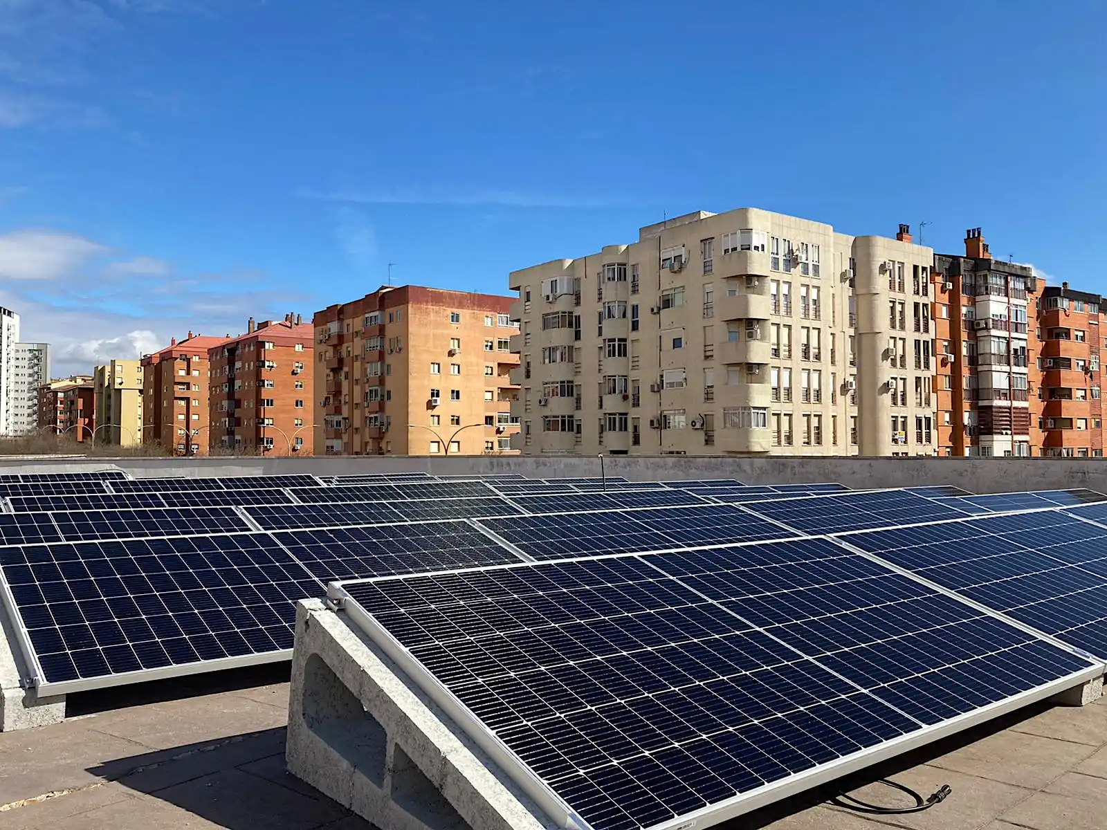 Photovoltaic solar panels installed on the rooftop of an urban residential building