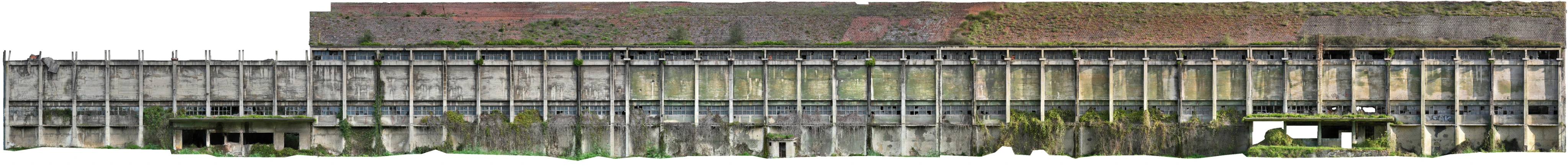 Panoramic view of the longitudinal façade of a Nitrastur industrial building before its rehabilitation.