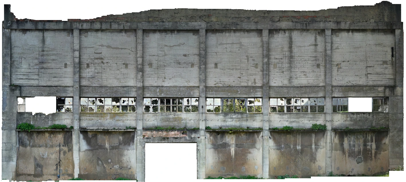 Façade of a Nitrastur industrial building before rehabilitation with partially preserved windows.