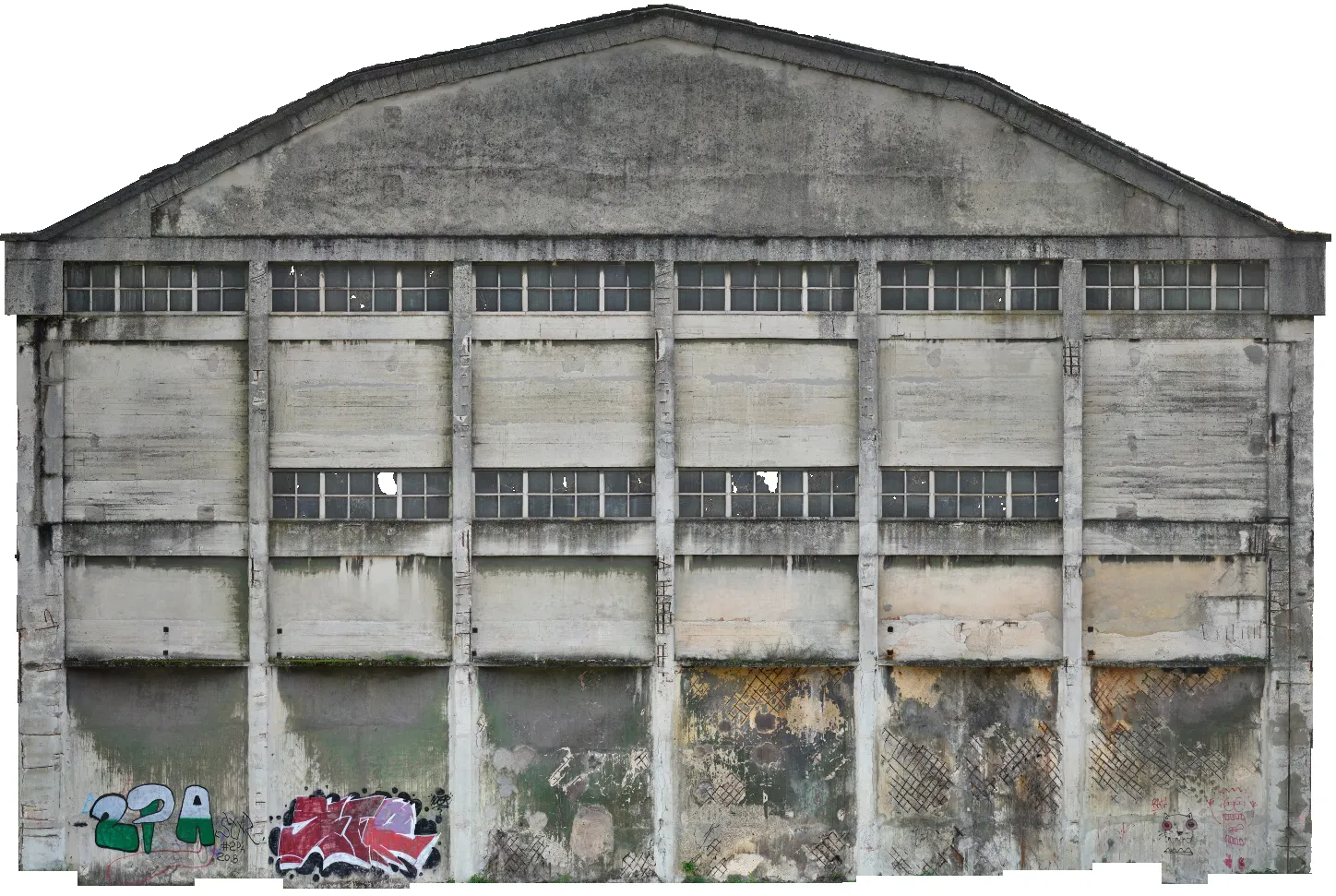 Side façade of an abandoned Nitrastur industrial warehouse with concrete walls and windows.