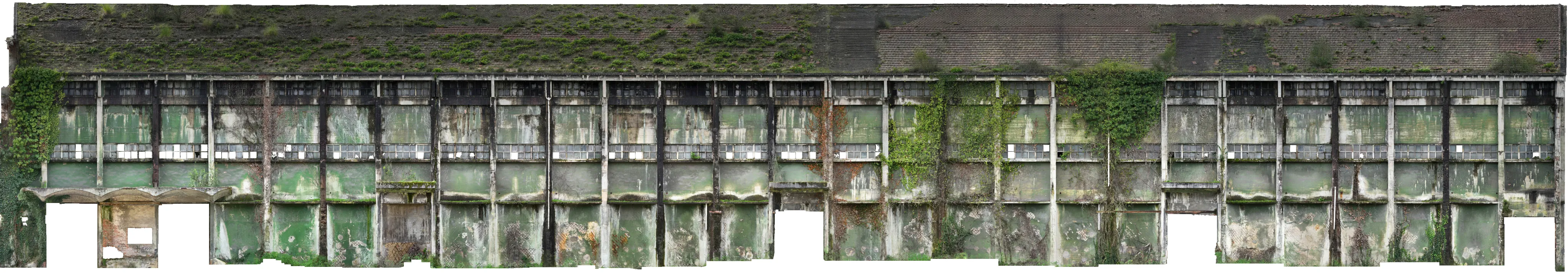 Panoramic view of a Nitrastur industrial building façade before its rehabilitation.